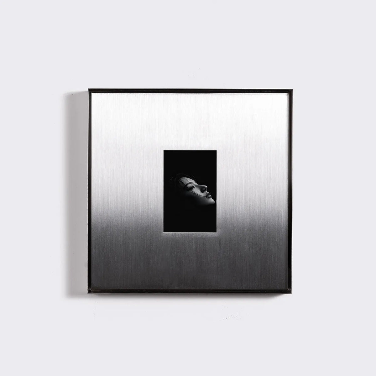 Square Stainless Steel Picture Frame in a warmly lit room