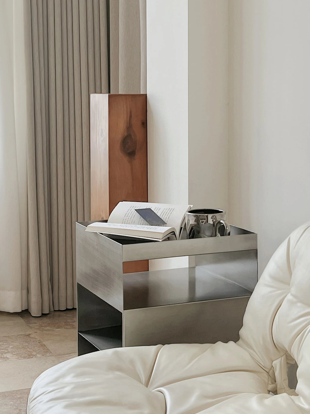 Bauhaus Minimalist Metal Side Table beside a lounge chair
