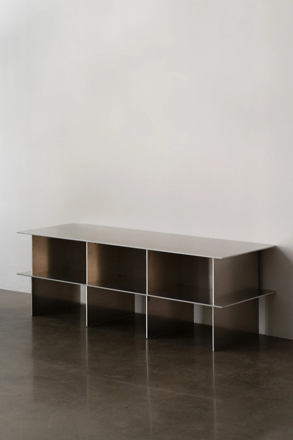 Glossy Metal Minimalist TV Stand in a bright, styled room